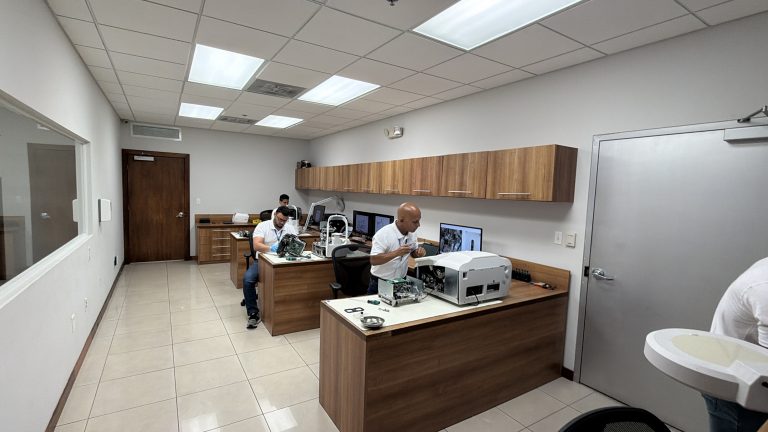 Technicians at their workbenches in the service lab