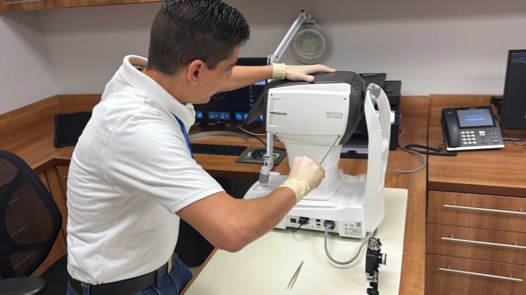 Technician testing a diagnostic instrument at a workbench