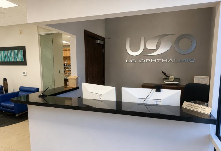 US Ophthalmic reception desk with the company logo